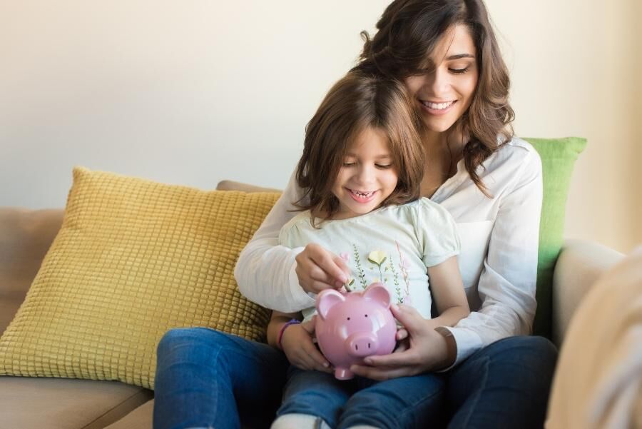 Mutter und Tochter mit Sparschwein mutter-tochter-sparen-umgang-mit-geld-lernen